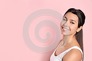 Young woman with healthy teeth on color background