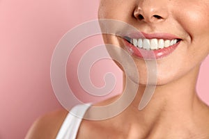 Young woman with healthy teeth on color background