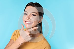 Young woman with healthy teeth on color background