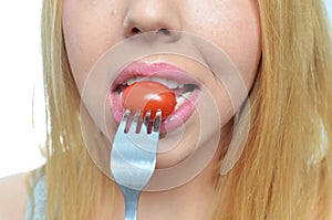 Young woman with healthy tomato