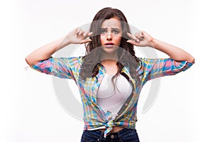 Young woman with a hearing disorder or hearing loss cupping her hand behind her ear