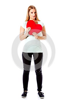 Young woman with a heart pillow in her hands - Valentines day concept.