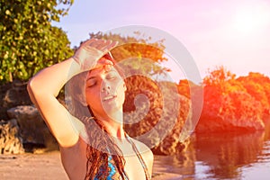 Young woman with heatstroke. Dangerous sun. Beach life. Girl under sun. photo