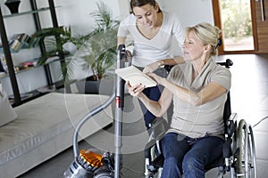 Young woman helping disabled lady