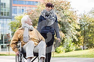 Young woman helping disabled relative