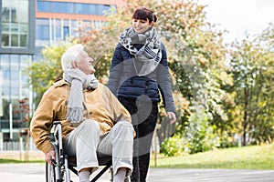 Young woman helping disabled relative photo