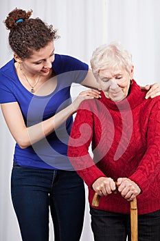 Young woman helping elderly lady