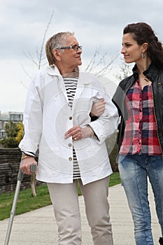 Young woman helping elderly person