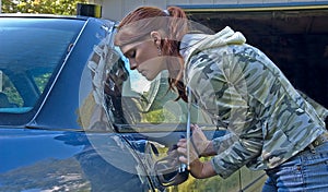 Young Woman Helping to Fix Car Door