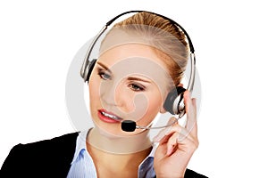 Young woman helpline operator is trying to hear something headphones