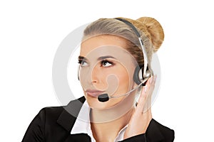 Young woman helpline operator is trying to hear something headphones