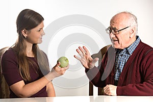 Young woman helps senior man