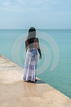 Young woman on her back enjoying the beach. Summer vacation concept