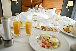 Young woman and her boyfriend are relaxing in a hotel