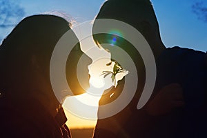 Young woman and her child smelling forest flower.