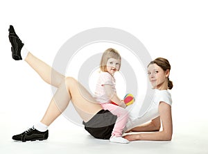 Young woman and her daughter doing sport exercises