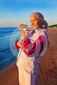 Young woman with her dog on a beach