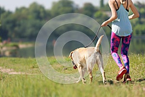 Young woman and her dog spending time together