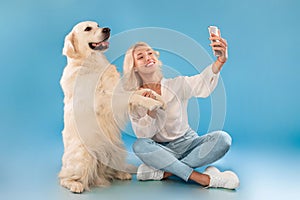 Young woman with her dog taking selfportrait