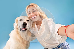 Young woman with her dog taking selfportrait