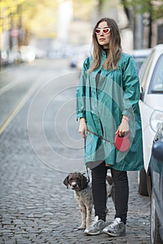 young woman with her dog waiting for a taxi