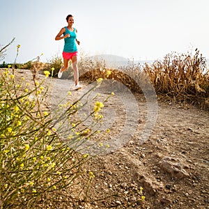 Young woman on her evening jog along the seacoast