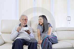 Young woman and her father talking together