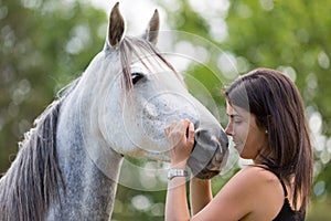 Young woman with her horse