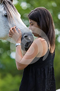 Young woman with her horse