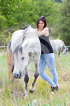 Young woman with her horse