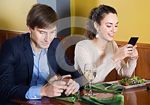 Young woman her husband sitting at restaurant table