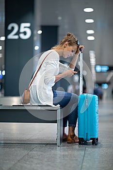 Young woman with her luggage at an international airport