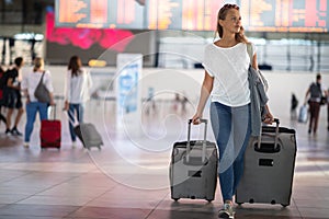 Young woman with her luggage at an international airport