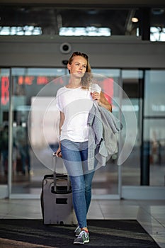 Young woman with her luggage at an international airport