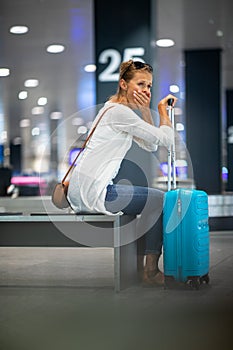 Young woman with her luggage at an international airport