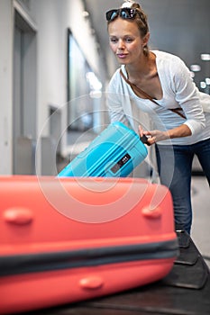 Young woman with her luggage at an international airport