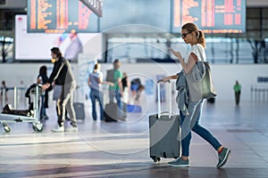 Young woman with her luggage at an international airport