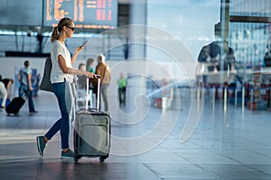 Young woman with her luggage at an international airport