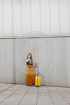 Young woman with her luggage looking for her vacation break