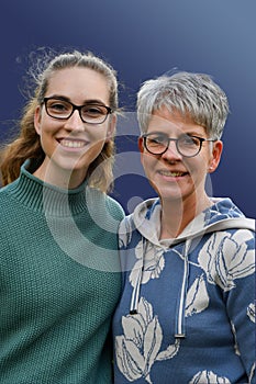 Young woman and her mother with colour coordinated clothing