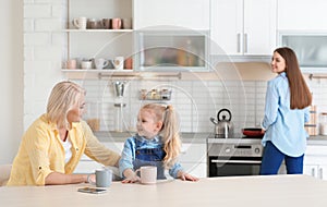 Young woman, her mother and daughter spending time