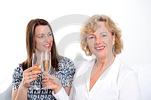 Young woman and her mother drinking champagne