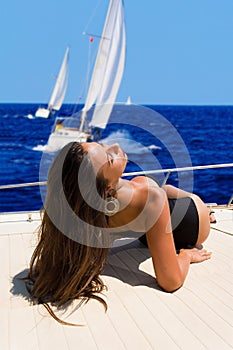 Young woman on her private yacht