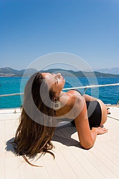 Young woman on her private yacht