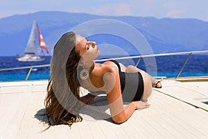 Young woman on her private yacht