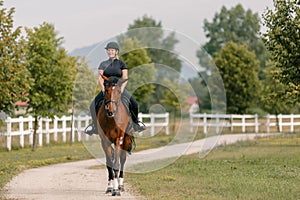Young woman and her red horse during a calm trail ride
