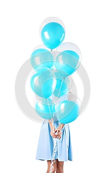 Young woman hiding behind air balloons