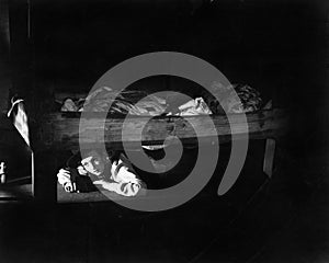 Young woman hiding under the bed