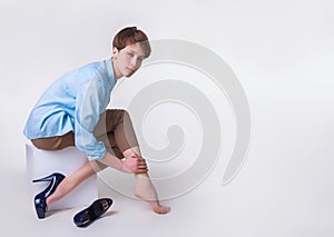 Young woman in high heels massaging her tired legs