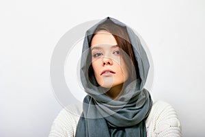 Young woman in headscarf or hijab inside.
